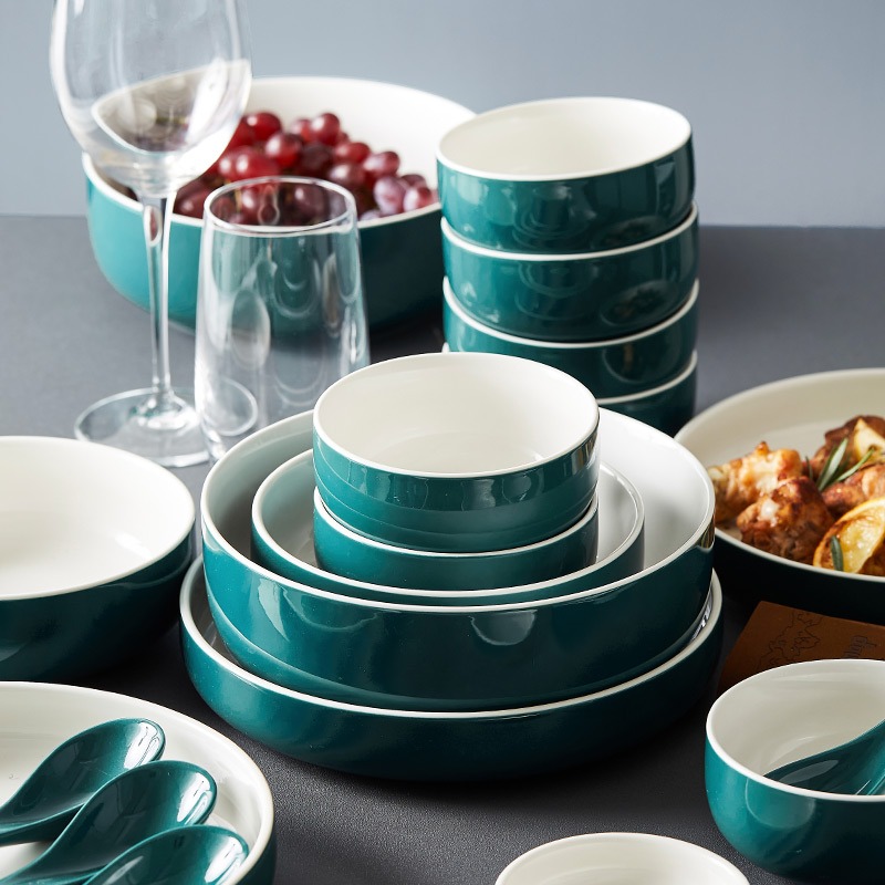 Dark Teal and White Ceramic Dinnerware Set with Wine Glasses and Grapes