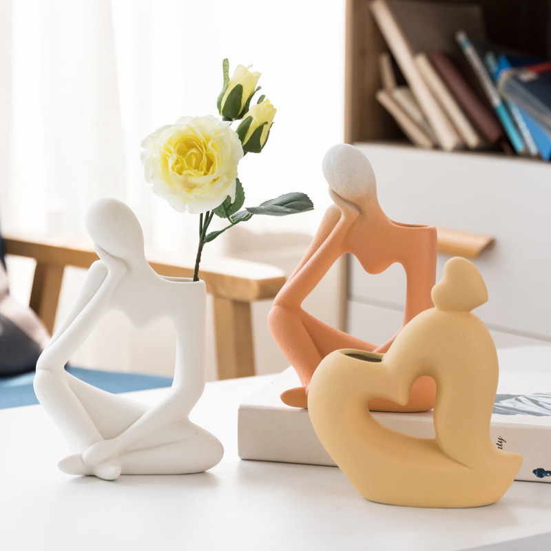 White Orange and Yellow Abstract Sitting Figure Ceramic Vases with Rose